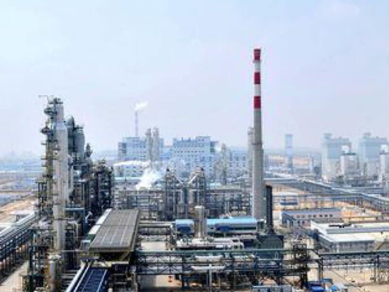 Aerial view of the chemical manufacturing site that is part of the Shaanxi Yanchang Zhongmei Yulin energy and chemical plant in Jingbian City, Shaanxi province in northern China, with a complex array of buildings, pipes, vehicles and smokestacks emitting water vapor
