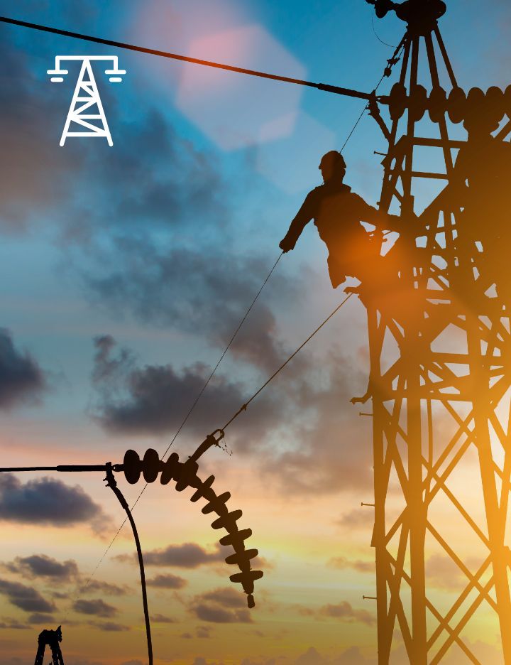 An electrical worker at the top of an electrical tower