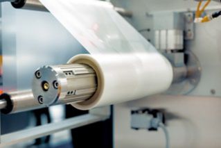 Roll of packaging film. Feeding unit of a modern packaging machine.