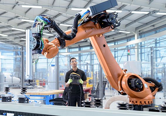 Engineer operating robotic manufacturing equipment