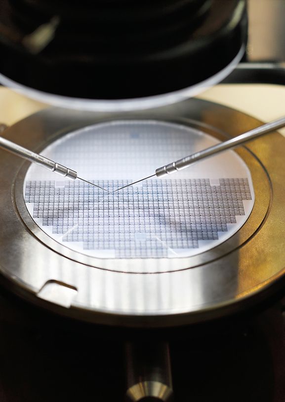 Three technicians in front of semiconductor manufacturing equipment that uses Kalrez® seals.