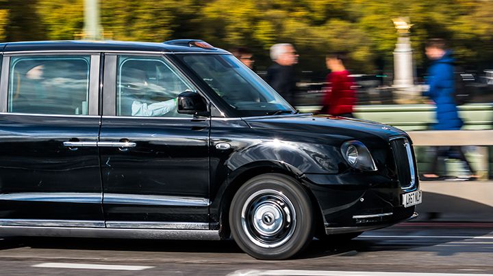 Electric TX5 London Black Taxi moving right to left