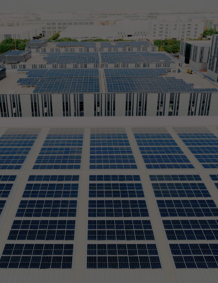 Grids of solar panels arranged on buildings' rooftops.