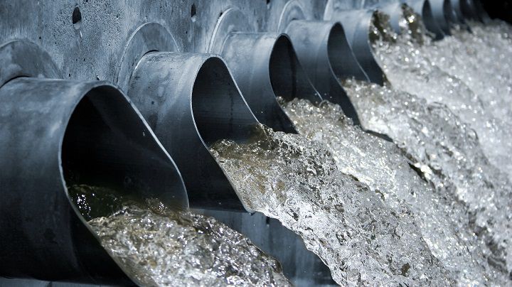 Industrial wastewater flowing out of steel pipes