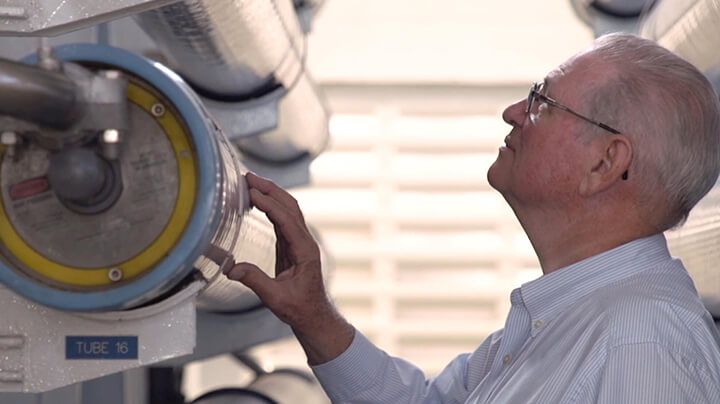 Person inspecting an installed FilmTec Fortilife reverse osmosis element