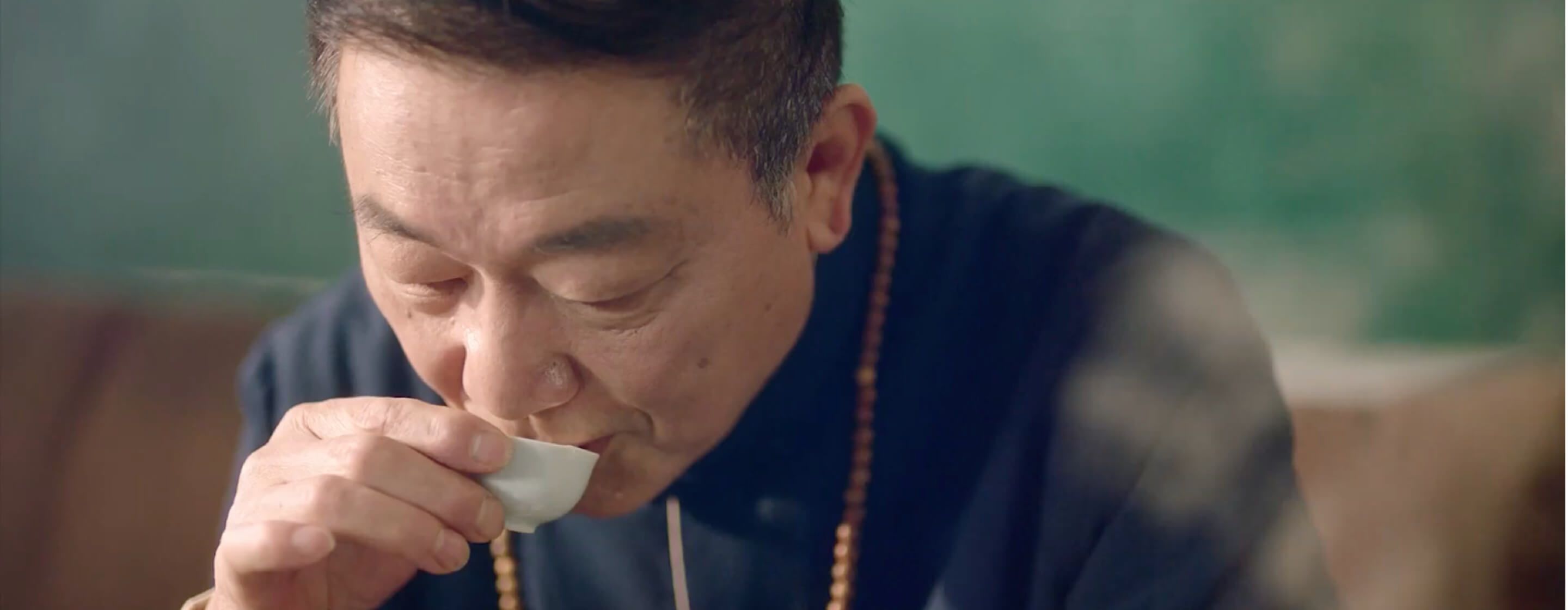 Older man drinks tea made from clean household water in a delicate porcelain tea cup.