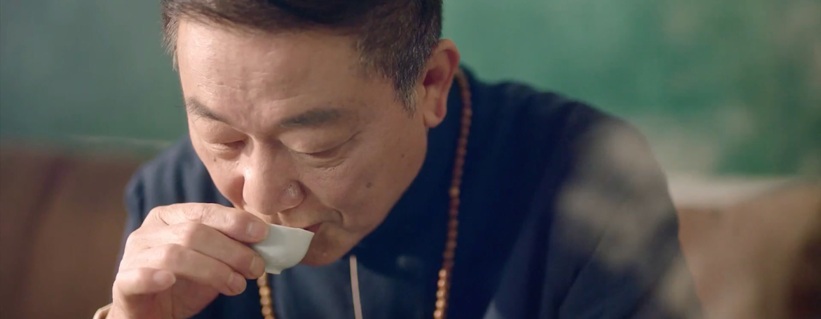 Older man drinks tea made from clean household water in a delicate porcelain tea cup