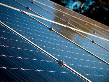 Man working on solar panel display